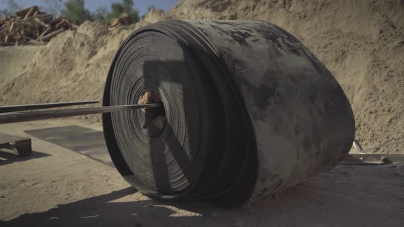 Loader Raising Black Rubber Conbeyor Belt for Bulk Materials Outdoors. Heavy Industrial Machinery