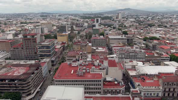 Drone Flight Over Building Rooftops From Monument Of Fray Antonio Alcalde In Guadalajara, Mexico. ae