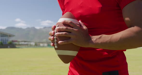 American football player holding a ball