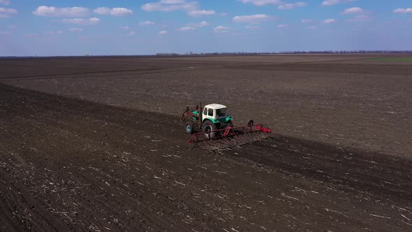 Tractor Cultivating Field at Spring Aerial View