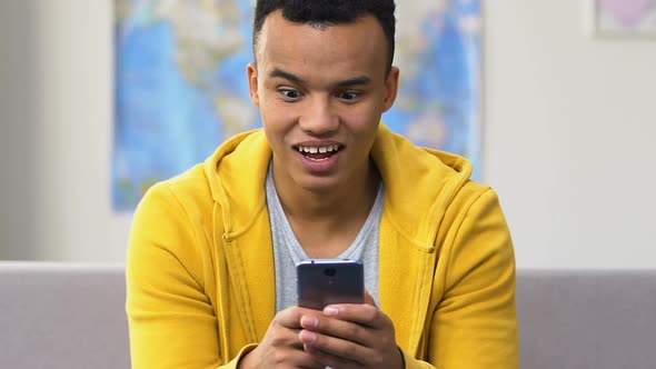 Surprised Black High Schooler Browsing Smartphone, Modern Dating Social Apps