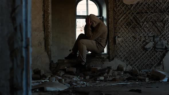 An Angry Man In An Old Ruined Building. Sad Person, Problems At Work Or In Life, A Person Depressed