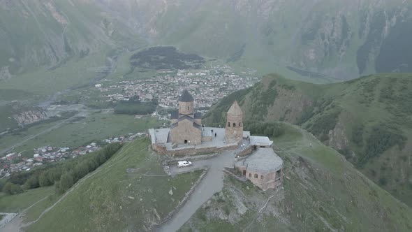 Stepantsminda, Georgia - May 8 2021: Aerial view of Gergeti Trinity Church, Tsminda Sameba. Kazbegi