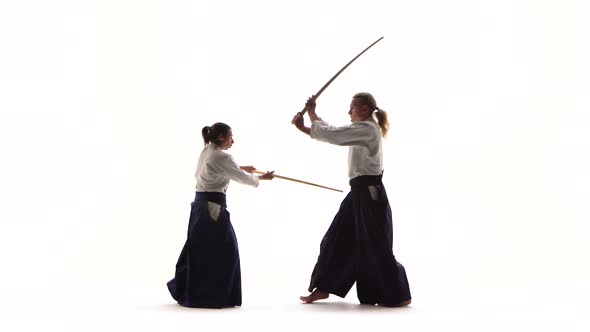 Male, Female Demonstrating Aikido Using Bokken. Isolated, White. Close Up.