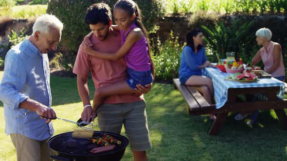 Happy girl, father and grandfather preparing barbecue 4k