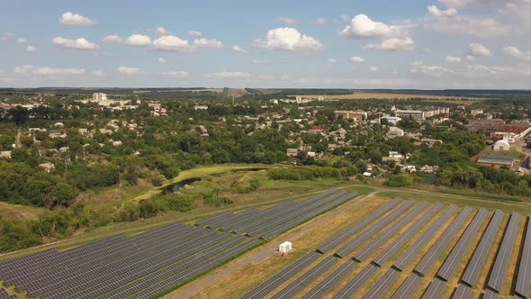 Aerial view of the Solar panels on a hill above the river