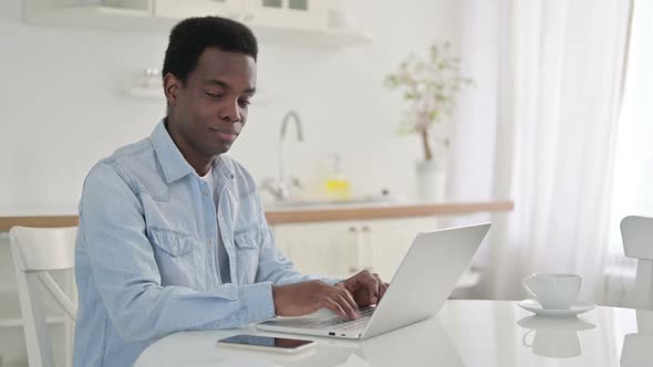 Thumbs Up By Positive African Man with Laptop