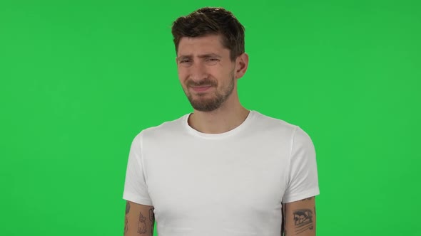 Portrait of Confident Guy Is Showing Disgust for Bad Smell or Taste. Green Screen