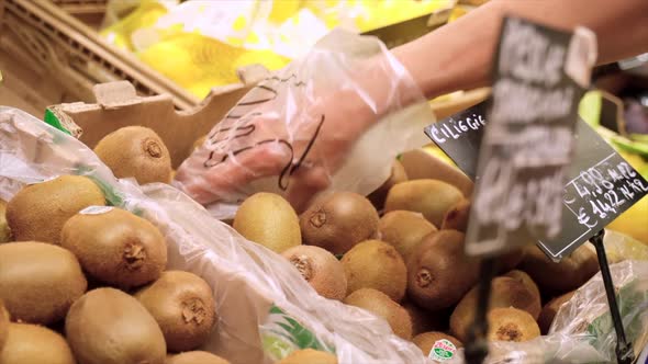 Picking Kiwi Fruit in the Market