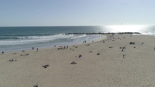 Aerial shot of people on the beach alt