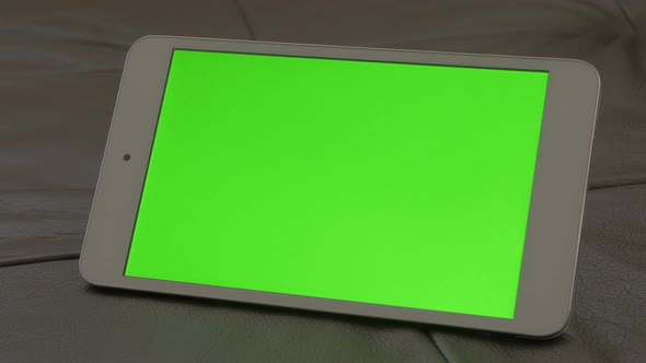 Modern silver and white tablet computer green screen display panning 4K 2160p 30fps UltraHD footage 