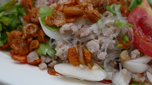 Close-Up Footage of Yum Woon Sen (Spicy Vermicelli and Seafood Salad), One of the Favourite Thai Str