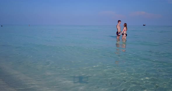 Young man and woman married on vacation enjoy life on beach on paradise white sand 4K background