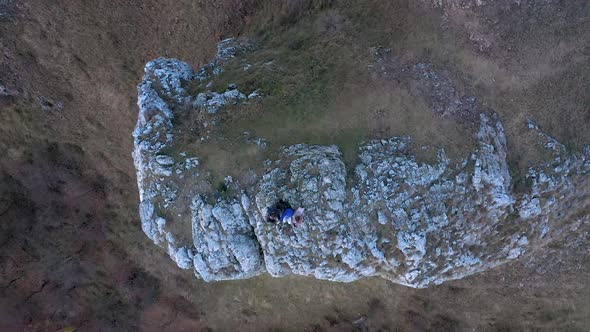 Group of Friends Resting on a Mountain Cliff