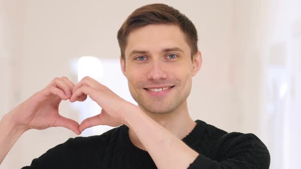 Portrait of Heart Sign By Happy YOung Man