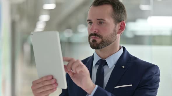 Portrait of Businessman Using Digital Tablet