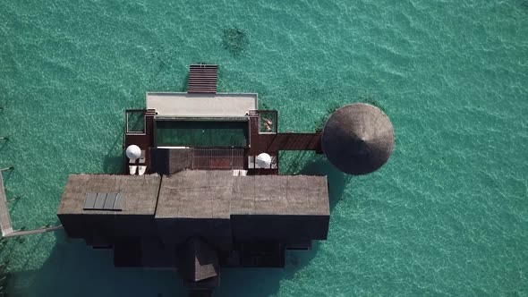 Huge water villa at the Maldives resort in the middle of the ocean. view from above. 4K
