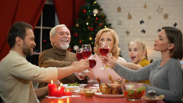 Cheerful Family Clinking Wineglasses on Xmas Eve