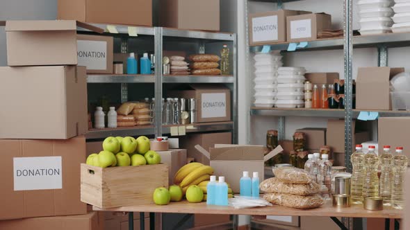 Various Boxes of Grocery Standing on Shelves at Food Bank