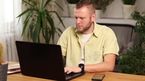 Freelancer man working with laptop on the table at home