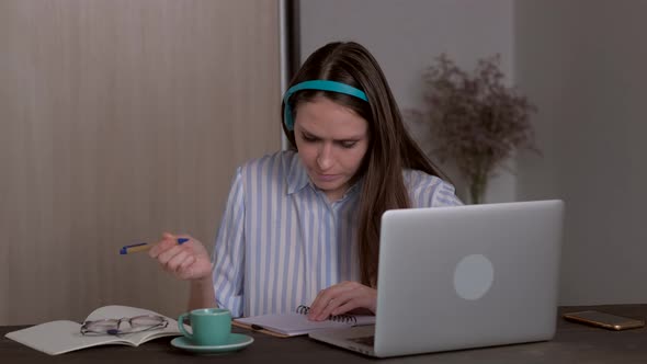 Young Female Student in Headphones Studying at Home Online Education