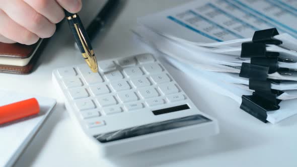 Close Up of Male Accountant or Banker Making Calculations