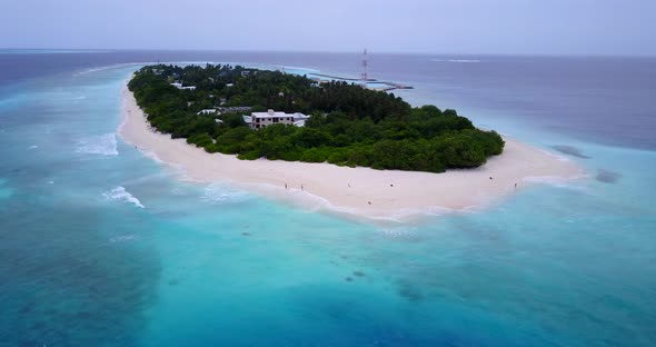 Wide angle birds eye tourism shot of a summer white paradise sand beach and aqua blue ocean backgrou