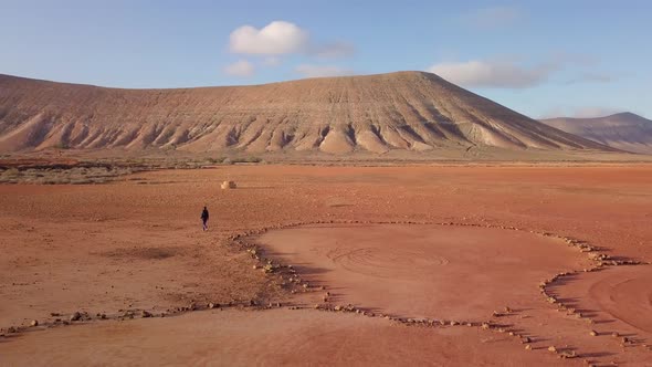 Amazing desert drone footage with isolated old man walking back home