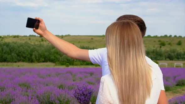 Lovers Take a Selfie in a Lavender Field