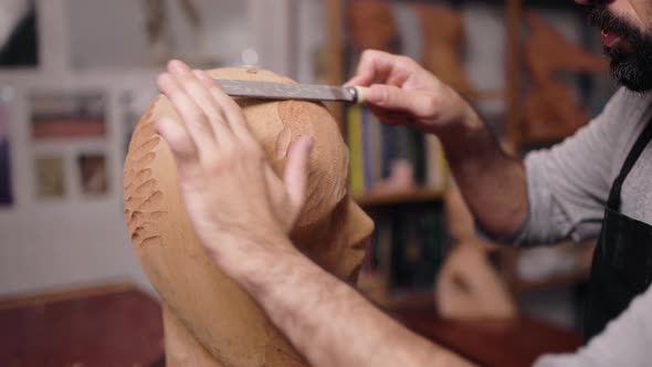 Anonymous craftsman polishing wooden detail