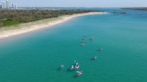 A large group of kayaks exploring the coastline