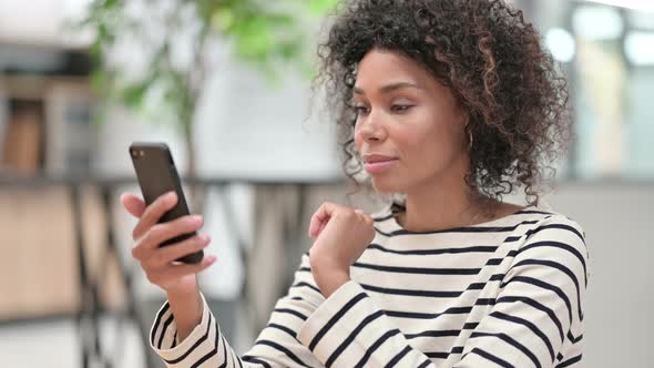 Close Up of Young African Woman Using Smartphone