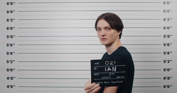 Side Profile Mugshot of Male Person with Dark Hair Turning Head and Looking to Camera