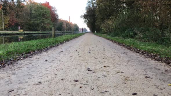 Walking on a Sandy Road Next to a River