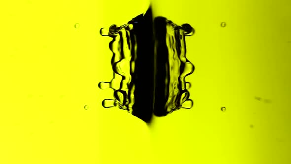Vertical Video A Drop of Water Falls on Surface of a Liquid in Slow Mo Bright Yellow Background