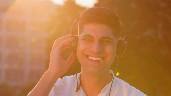 Overjoyed Millennial Middle Eastern Young Man Have Fun Enjoying Tracks in Headphones Excited Smiling