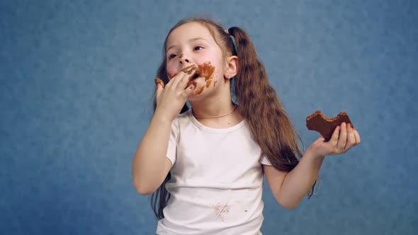 Girl with chocolate plate. Little girl eating chocolate plate on table