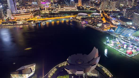 Singapore Cityscape with Yachts on Water Night Time-lapse. Pan Up