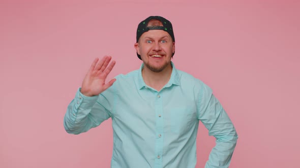 Bearded Man Smiling Friendly at Camera and Waving Hands Gesturing Hello or Goodbye Welcoming