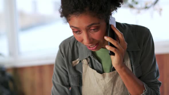 Pretty African woman talking by phone alt