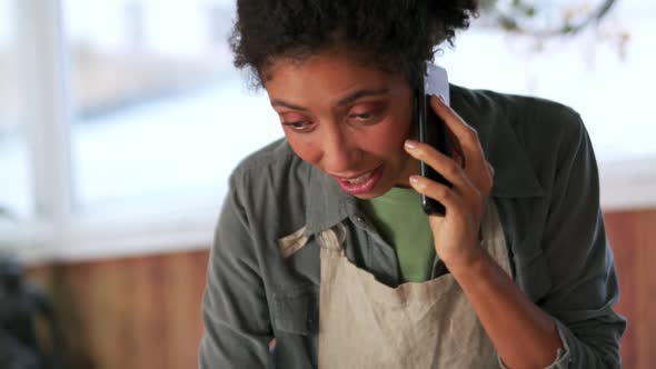 Pretty African woman talking by phone