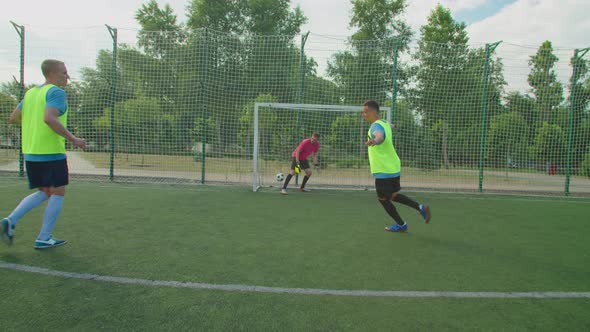 Soccer Player in Sportswear Taking Penalty Kick Scoring Goal Outdoors