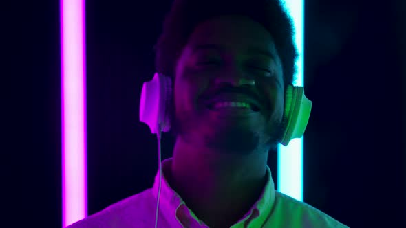 Portrait Young Stylish African American Male Wearing Big White Headphones Smiling Enjoying Music