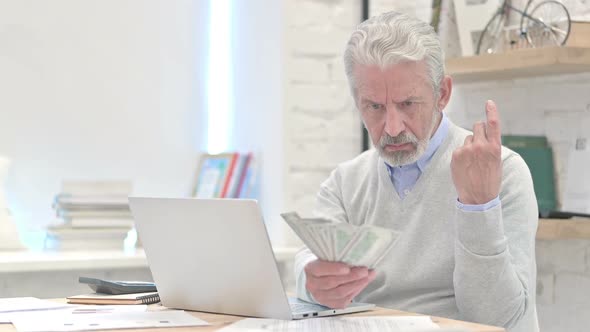 Thinking Old Man Holding Dollars in Hand