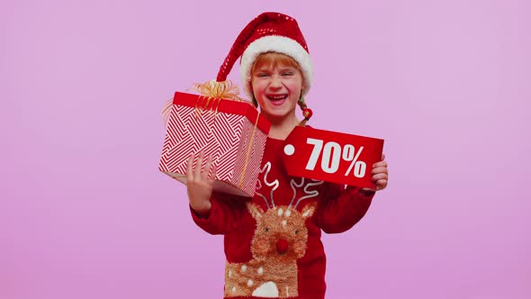 Girl Kid in Red Christmas Hat Showing Gift Box and 70 Percent Discount Inscriptions Banner Text Note