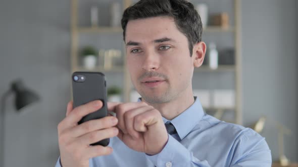 Portrait of Young Man Busy Using Smartphone