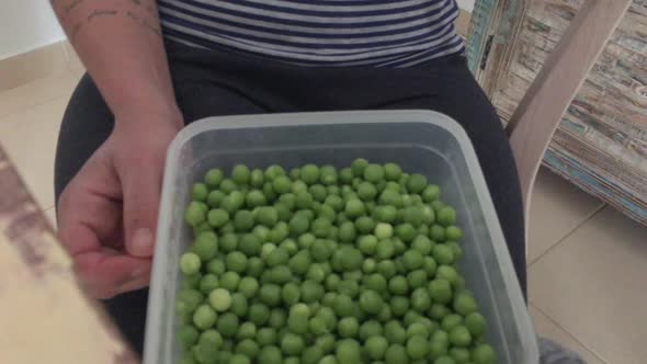 Footage of Mother and little son shelling Green Peas At Home SLOW MOTION