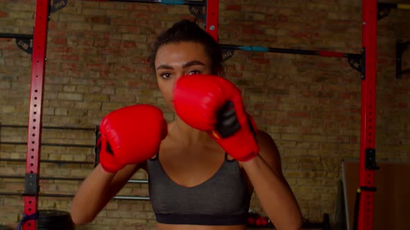 Determined Sporty African American Female Fighter Performing Shadow Boxing