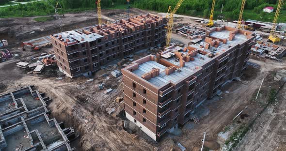 Construction site of low-rise brick houses in summer. Aerial view