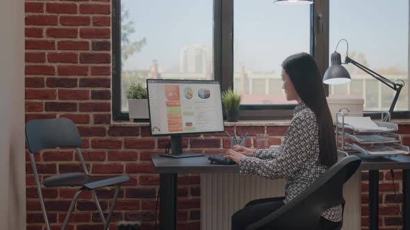 Employee Using Computer to Work on Startup Business Plan